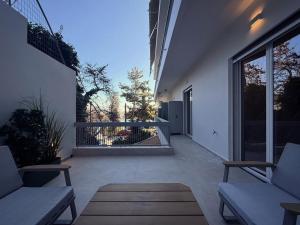 a patio with two couches and a large window at Central Luxury Sea View Apartment in Chalkida