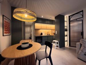 a living room with a table and a kitchen at Central Luxury Sea View Apartment in Chalkida