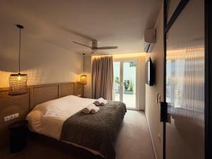 a bedroom with a bed with two towels on it at Central Luxury Sea View Apartment in Chalkida