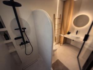 a bathroom with a sink and a surfboard on the wall at Central Luxury Sea View Apartment in Chalkida +12 photos