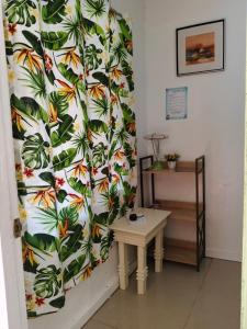 a room with a table and a curtain with leaves at Cronin Residences in Oslob