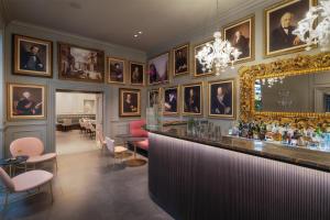 a bar in a room with portraits on the wall at WorldHotel Casati 18 in Milan +45 photos