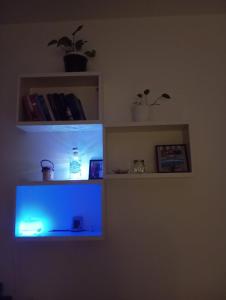 a room with a blue light on a shelf at Casa Martina in Cogoleto
