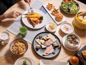 a table with plates of food on a table at JW Marriott Hotel Shenzhen in Shenzhen
