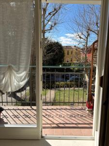an open door to a porch with a gate at Casa Polly in Rovereto