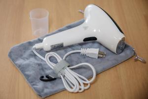 a hair dryer sitting on a table with a glass at Anecis笠取町2 in Nagoya