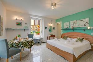 a bedroom with a bed and a table and a room with at Vida Boa Apartments in Nago-Torbole