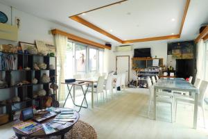 a living room with a table and chairs at Minshuku Irayoi in Ishigaki Island