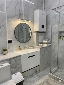 a white bathroom with a sink and a mirror at Studio MD in Chişinău +8 photos
