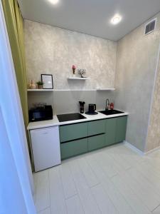 a kitchen with a sink and a counter top at A-Six Apartment, ЖК Достар 26 in Karagandy +19 photos