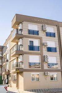 a tall apartment building with windows and balconies at 2 Bedroom Cozy Apartment in Antalya