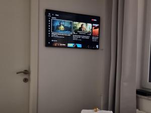 a flat screen tv hanging on a wall at Eigene Wohnung I St Gallen I Appenzell I Bodensee I St Anton I Seealpsee in Rebstein