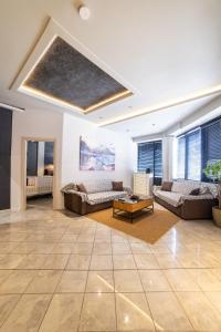 a large living room with couches and a table at Omega Suites 30 in Tríkala