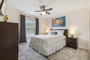 a bedroom with a bed and a ceiling fan at 601 Benedictine Ter in Sebastian +28 photos
