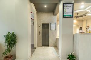 a hallway with a door in a building at Treebo Aashirwad Bliss Inn With Swimming Pool in Jaipur +27 photos