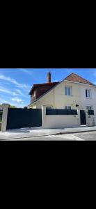 a white fence in front of a white house at Chambre Maria in Le Pollet