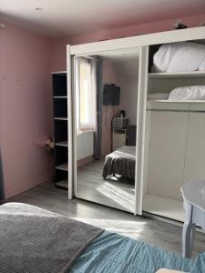 a mirror in a bedroom with a bunk bed at Chambre Maria in Le Pollet