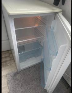 an empty refrigerator with its door open in a room at Chambre Maria in Le Pollet