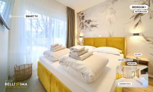 two beds in a room with towels on them at Villa Bellissima Malinska - Privater Pool, 4 Schlafzimmer, ruhige Lage in Malinska