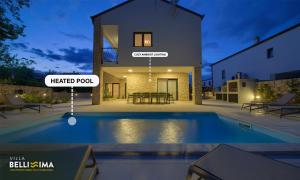 a villa with a swimming pool in front of a house at Villa Bellissima Malinska - Privater Pool, 4 Schlafzimmer, ruhige Lage in Malinska