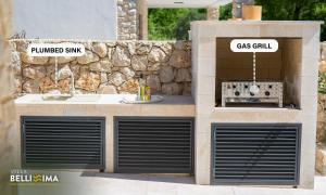 a building with two garage doors and a gas grill at Villa Bellissima Malinska - Privater Pool, 4 Schlafzimmer, ruhige Lage in Malinska +15 photos