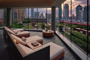 a living room with a view of a city skyline at Alila Shanghai in Shanghai