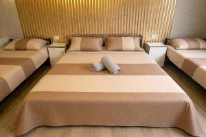 two beds in a room with two pillows on them at Andya in Constanţa