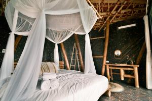 a bedroom with a bed with a canopy at Bamboo Hill in Lương Sơn