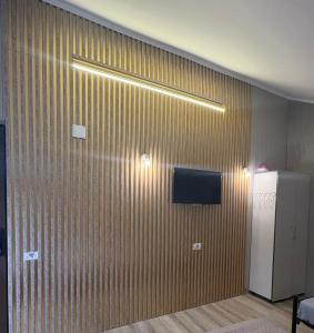 a room with a wooden wall with a refrigerator at Andya in Constanţa