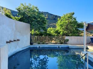 a swimming pool in a backyard with a fence at Casa Mimi B&B Adults Only in Gérgal