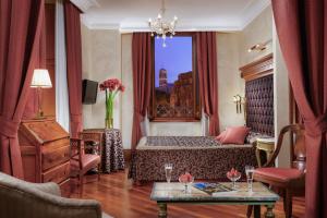 a hotel room with a bed and a table at Hotel Forum in Rome