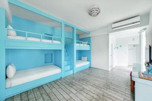 a blue bunk room with two bunk beds at Mare Cielo in Xiaoliuqiu
