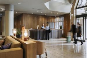a lobby with people standing at a reception desk at Adina Apartment Hotel Budapest in Budapest +34 photos