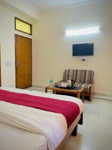 a hotel room with a bed and a couch at Hotel Har Ki Pauri with terrace Ganga view in Haridwār