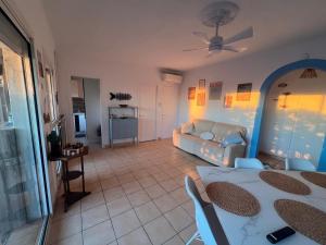 a living room with a couch and a table at Maison 5 chambres front de mer classée 3 étoiles tourisme in Narbonne