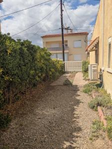 a pathway leading to a house next to a building at Maison 5 chambres front de mer classée 3 étoiles tourisme in Narbonne