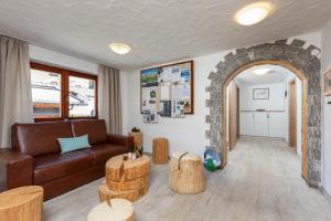 a living room with a couch and a brick wall at Garni Stefani in Vent