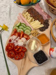 a cutting board with vegetables and other foods on a table at Nash-lak in Kaposvár +11 photos
