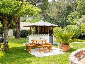 a picnic table and a gazebo in a yard at chambres d'hôtes villa OZ in Bidart