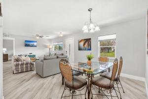 a dining room and living room with a glass table and chairs at 882 Cody Avenue in Sebastian