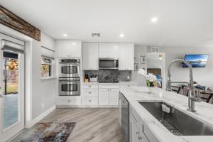 a kitchen with white cabinets and stainless steel appliances at 882 Cody Avenue in Sebastian
