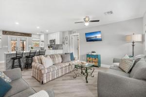 a living room with two couches and a kitchen at 882 Cody Avenue in Sebastian +40 photos