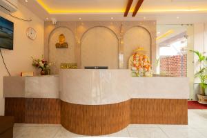 a lobby with a reception desk in a building at Hotel Panchvati in Durgāpur