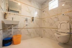 a bathroom with a toilet and a sink at Hotel Panchvati in Durgāpur