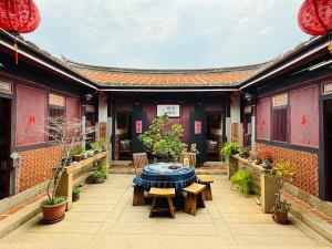 a patio with a table and chairs in a building at Grace Homestay in Jincheng