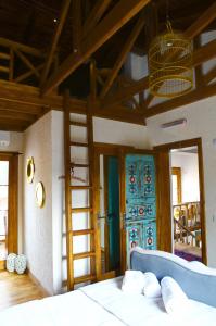 a bedroom with a bed and a ladder and a door at Ibri Hotel in Selcuk