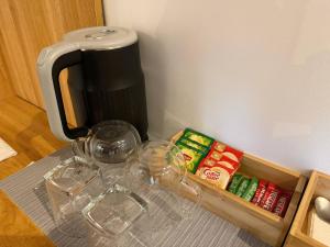 a table with wine glasses and a coffee pot at Apples&Pears Hotel in Manaoag