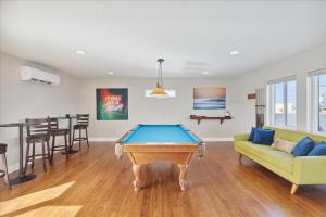 a pool table in a living room with a couch at 51 N Orlando Ave in Cocoa Beach