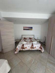 a bedroom with a bed with a blanket on it at Il Cirismiro in Torre Faro