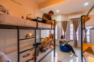 a group of people in a room with bunk beds at Zostel Guwahati in Guwahati